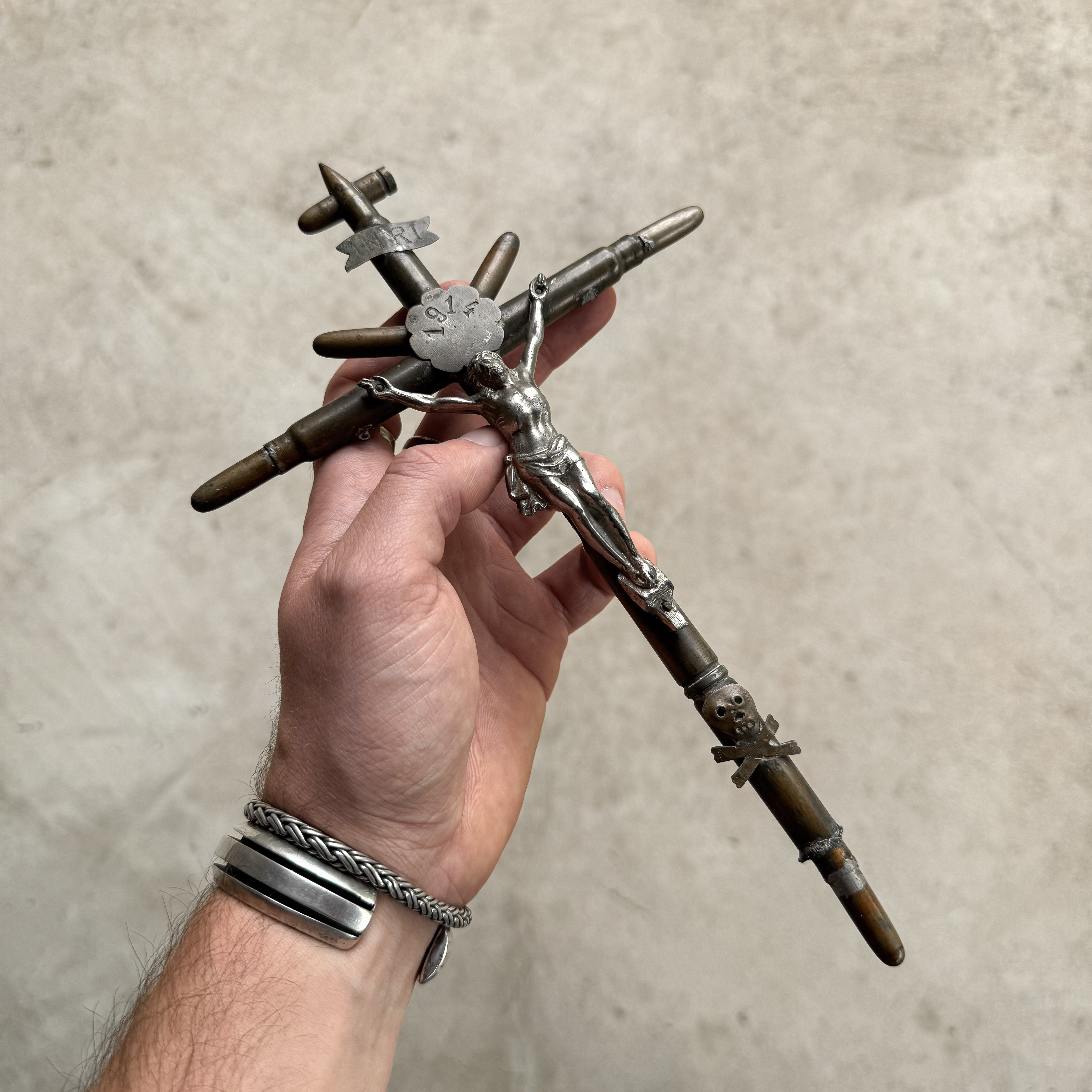 Antique WWI trench art crucifix made from bullets and shell casings, with a brass plaque engraved 1914 and INRI.