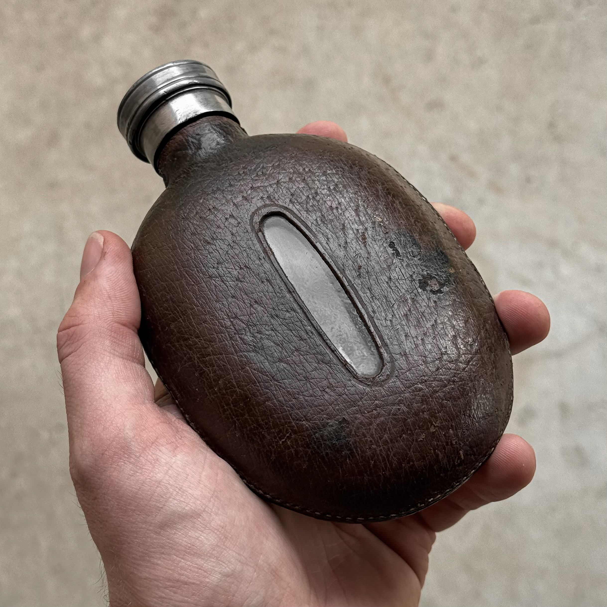 Vintage 1930s British hip flask with brown leather covering and pewter cap