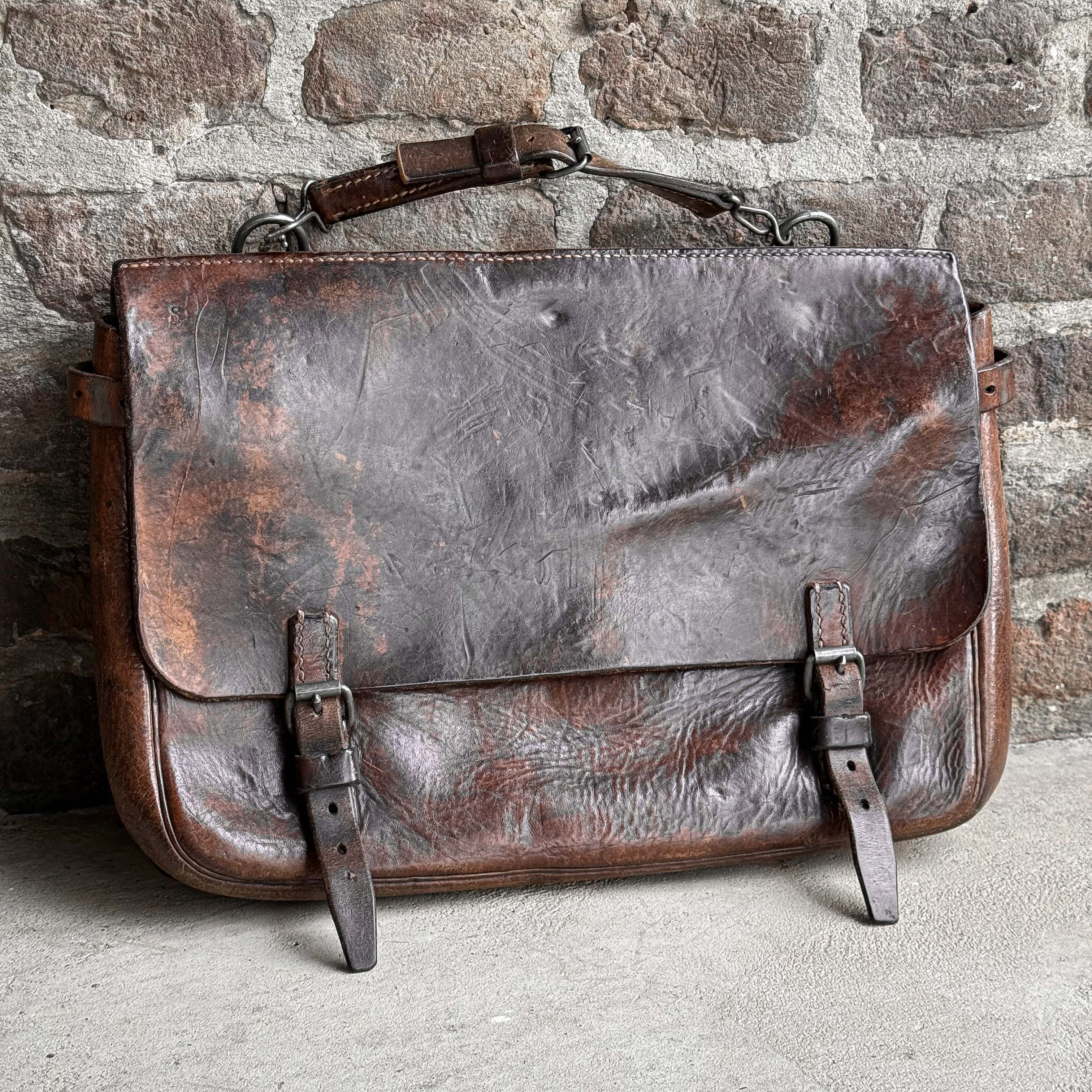 Vintage 1941 Swiss Army brown saddle leather bag with a later-added leather carrying handle.