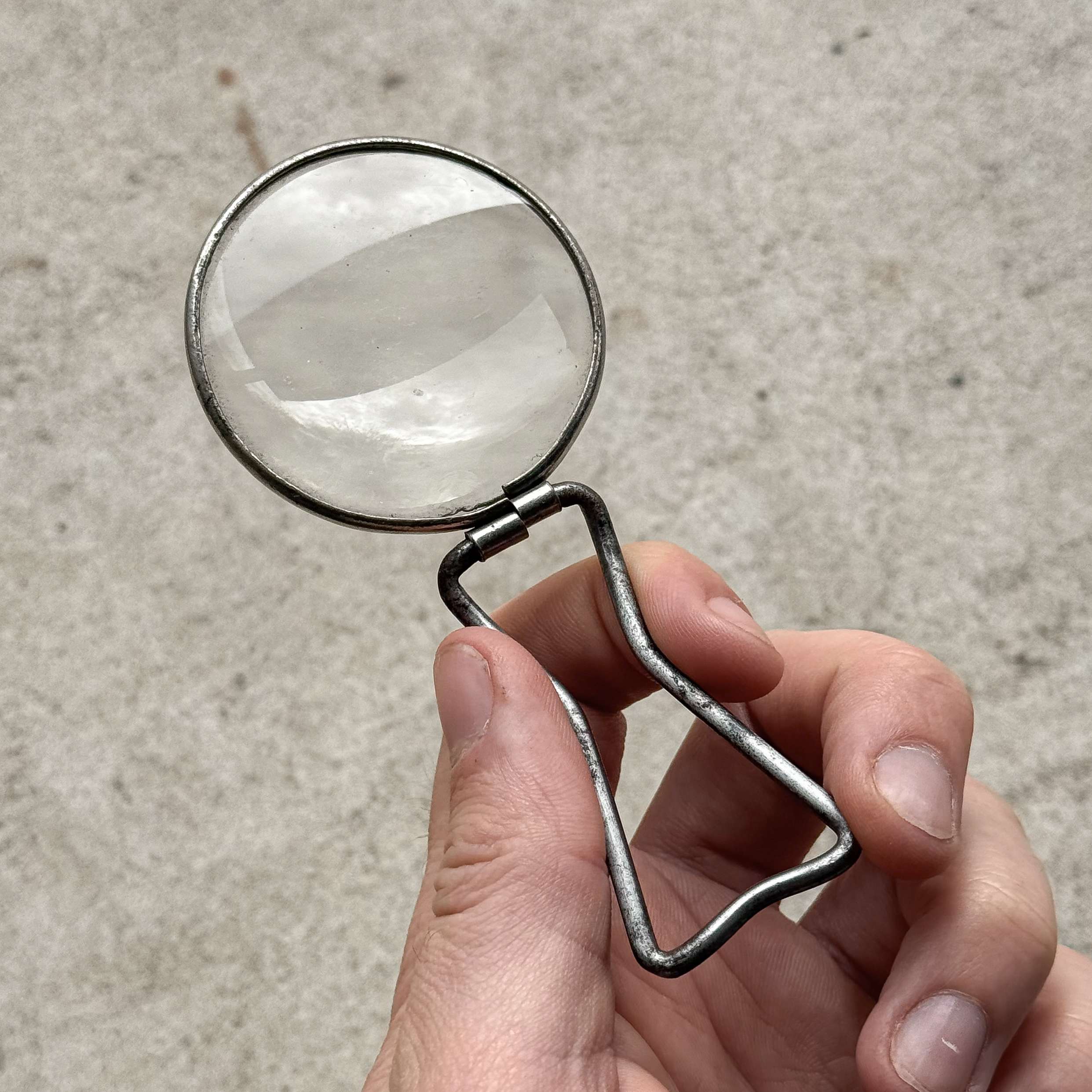 Vintage 1930s French folding magnifying glass with its small leather pouch.