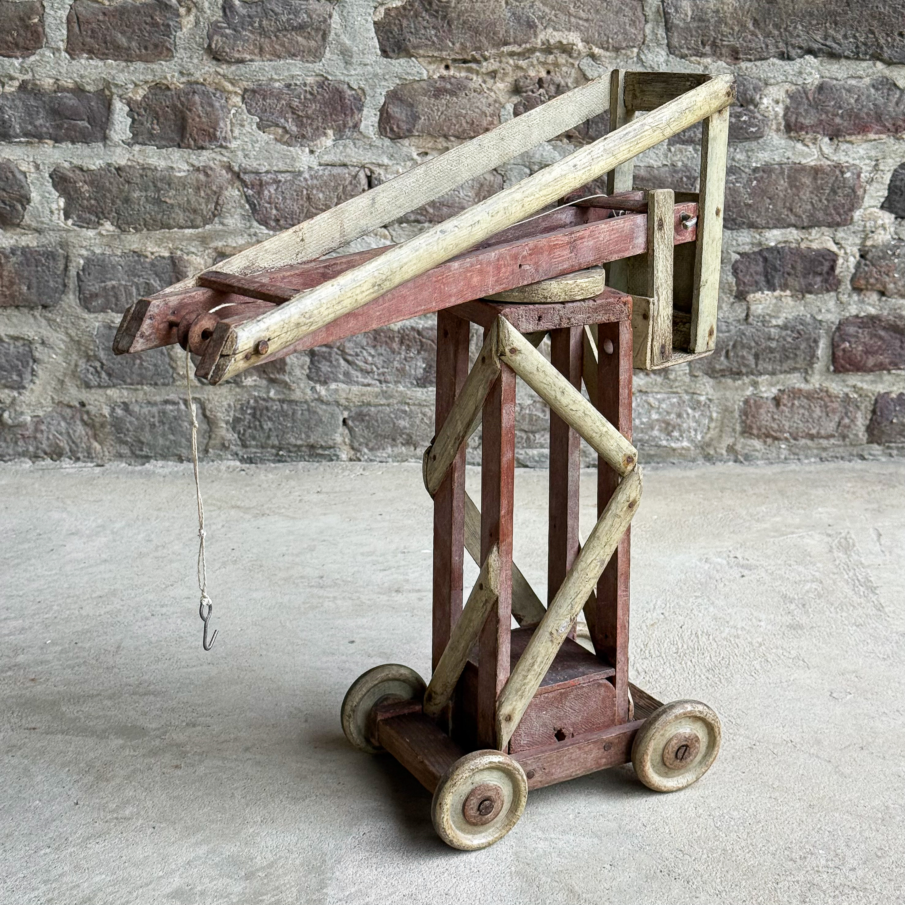 Vintage 1930s French handmade wooden toy crane with rope, hook and pulley.
