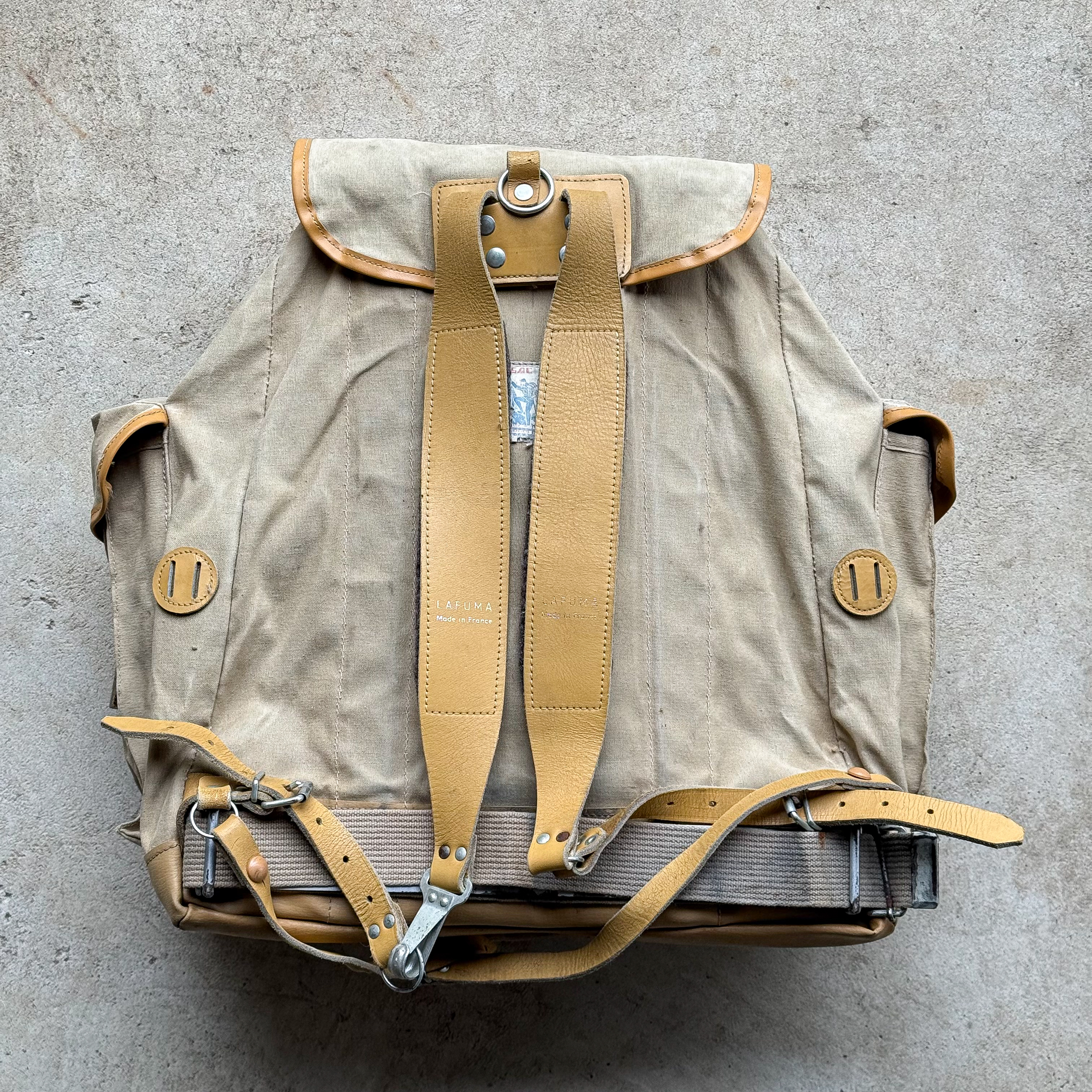 Vintage 1960s Lafuma canvas hiking rucksack with leather straps and souvenir patches